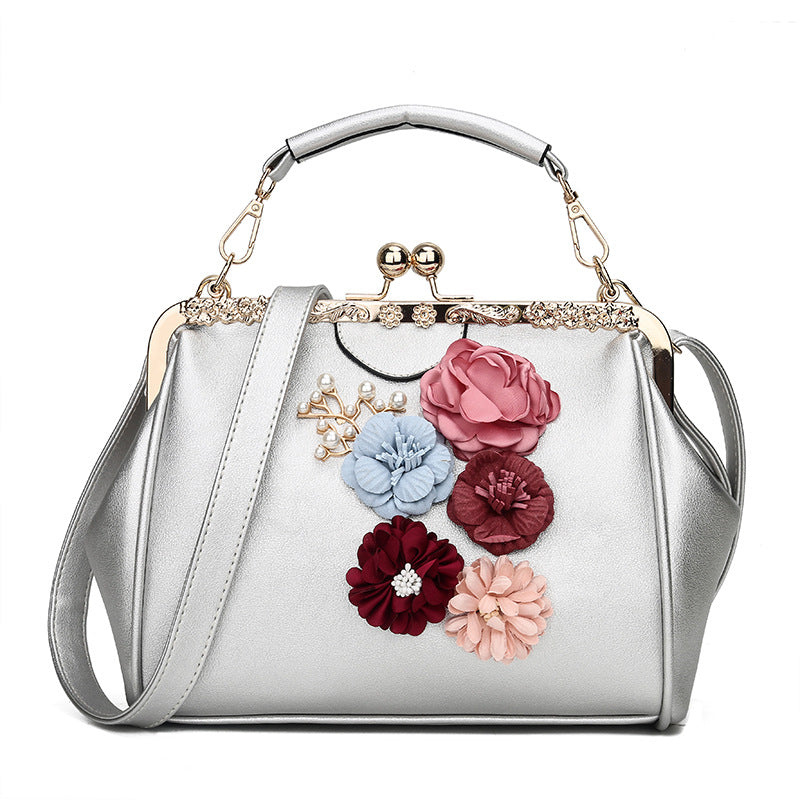 Embossed flower metal clip handbag