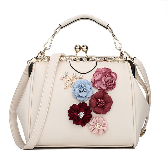 Embossed flower metal clip handbag