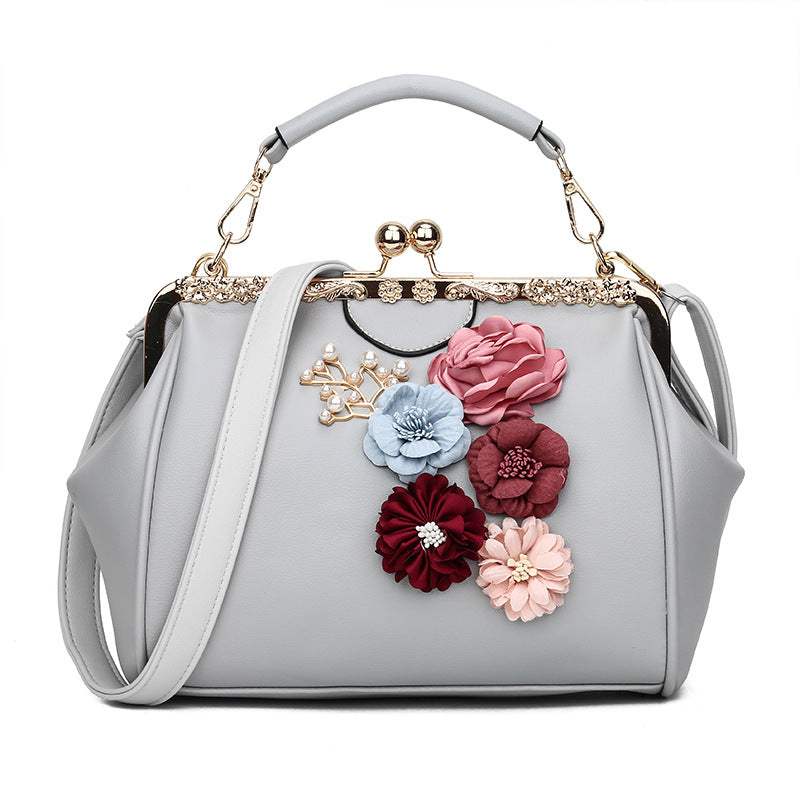 Embossed flower metal clip handbag