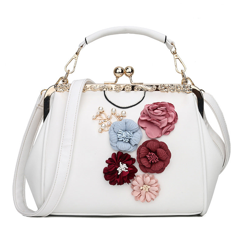 Embossed flower metal clip handbag